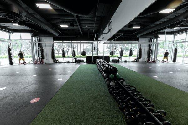 Turf and rubberized training area complete with medicine balls, kettlebells, and speciality bags.