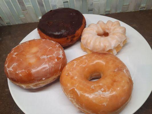 Raspberry filled, cream filled, vanilla cruller, and a plain glazed