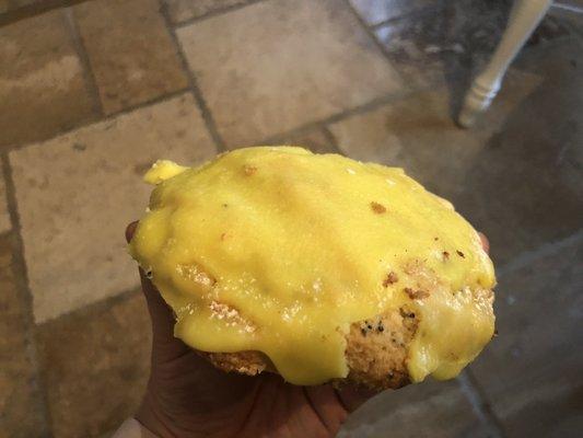 Lemon scone doused in thick crust of sugar glaze, over the top sweet.