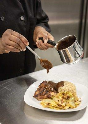 Putting the finishing touches on our authentic Jamaican Jerk Chicken meal.