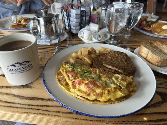 Omelette with sausage, toast and coffee