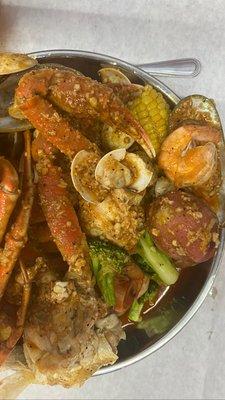 Dungeness crab, snow crab legs, baby clams, mussels, shrimps, potatoes, broccoli, and corns