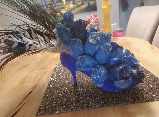 Stunning and fabulous blue rose arrangement inside a cobalt blue pump. The most unique bouquet I've ever seen! Thank you!