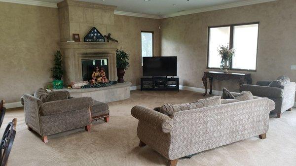 Faux finish walls, Precast stone fireplace and new carpet with crown moulding and baseboards with stained window trim.