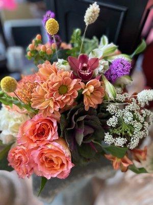 Gorgeous floral  arrangement in a square green planter.