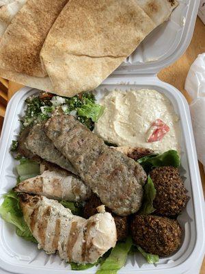 Trio plate. comes with more pita bread!!! 3 grilled chicken, 3 strips of beef gyro and 3 falafel over a salad, Tabouleh, and hummus