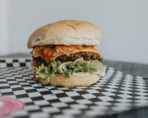 Indigō Burger made with Impossible™ patty. 100% Plant-based.