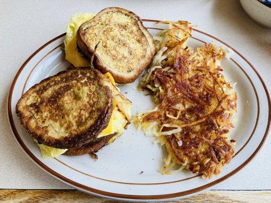 Homestyle Cinnamon Swirl Slammer: Sausage, Egg, and Cheese Sandwiches with Vlore Cinnamon Swirl Bread. Served with Hash Browns.