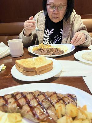 Enjoying our Steak and eggs .