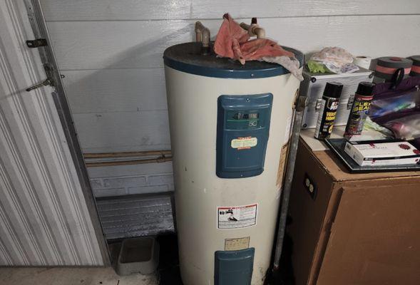 A close-up of a water heater located in a utility room, highlighting the condition and setup of the home's water heating syst...