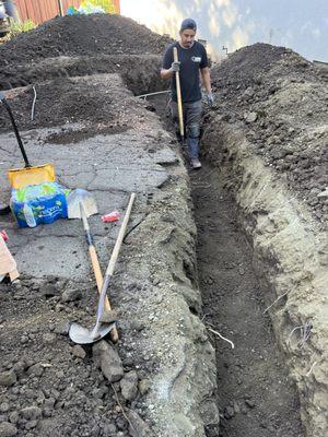 Measuring the trench for new sewer pipe