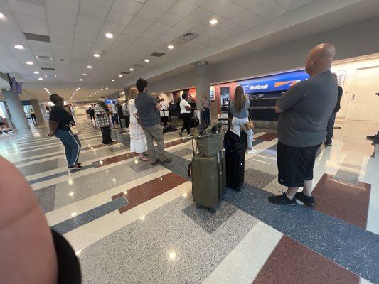 People are standing waiting for rental cars because this location does not have vehicles and is understaffed. The wait times are 1-2 hours.