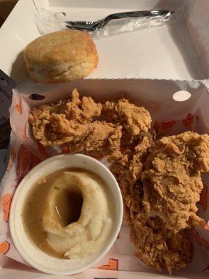 Yummy potatoes and gravy, along with their signature biscuit... and spicy chicken tenders