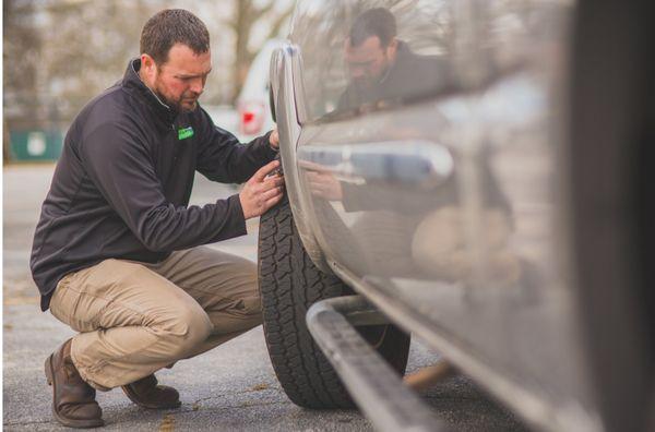 Kelly doing a tire inspection