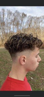 Men's skin fade and blonde highlights with foil on top