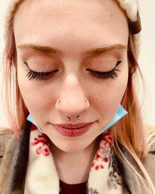 Nose piercings on both sides of the nose and a septum piercing. Almost Famous Body Piercing in Mankato, Minnesota