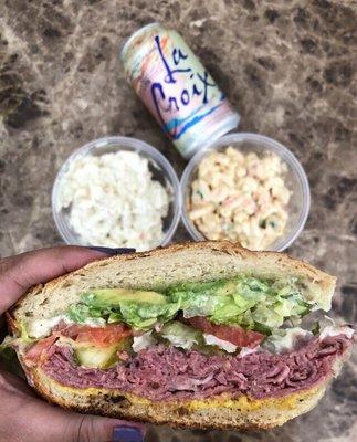 Hot Pastrami w/ provolone, avocado, everything, toasted sourdough | $8.49 (potato & mac salad in the back)