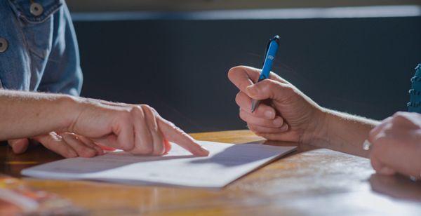 Customers signing documents at Flagstaff branch location.