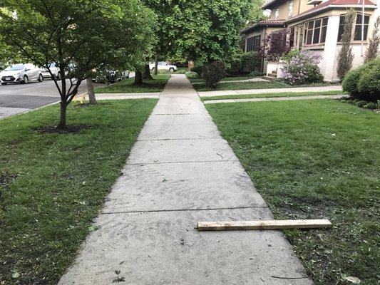 Tracks left on my sidewalk and in my lawn by vehicle used used to deliver shingles to site on my neighbor's property.