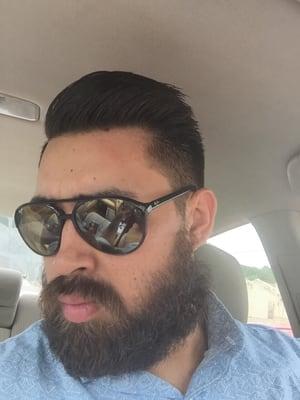 Pompadour style with a fade and hard part.