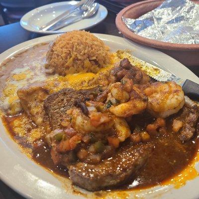 Carne Asada a la Tampiqueña (an enchilada and shrimp on top of a ny steak)