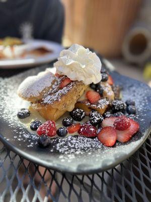 Brioche Cinnamon Roll French Toast with berries and danish cream