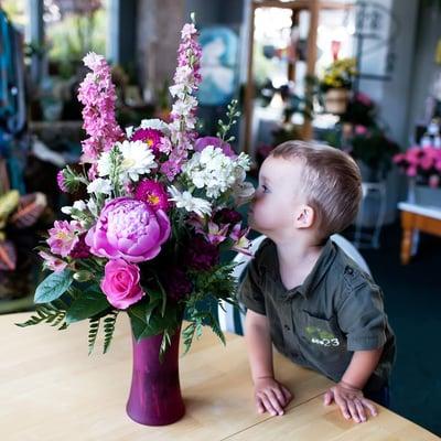 Youngest son smelling the peonies while he waits for for me to finish up in the office.