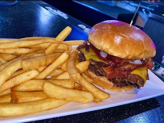 The "Double Bacon Smashburger" with a side of seasoned Fries.