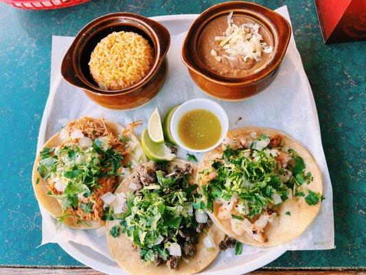 Carne asada, pollo, y camaron con arroz y frijoles.  Steak taco, chicken taco, and shrimp taco with a side of rice and beans