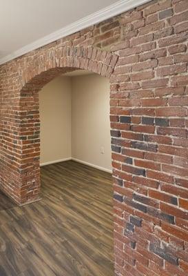 Original exposed brick and brand new plank flooring