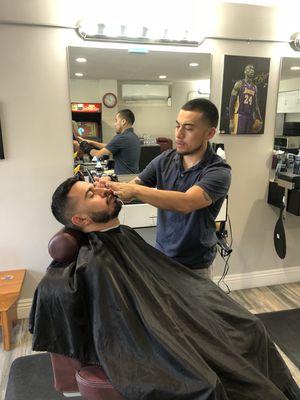 Jerry the barber performing beard and haircut service