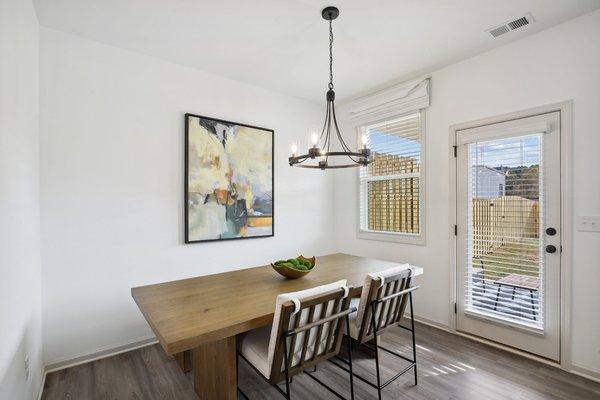 Dining area with hanging pendant light.