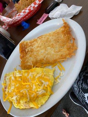 Ham and cheese omelette with homemade hash browns .