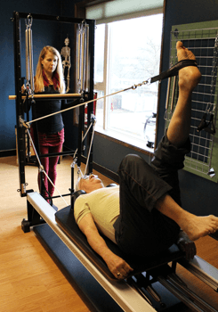 Susan B. Stack, working with Pilates client for functional movement