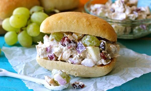 Chicken salad sandwich w/cranberries, pecans, and lettuce on french bread.