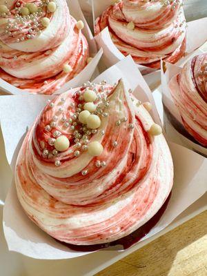 Raspberry Almond Cupcake. White cake filled with raspberry jam and topped with Almond buttercream and raspberry swirl