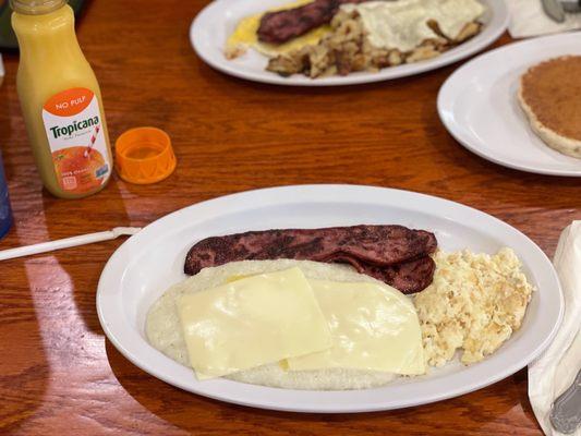 Cheese grits, Turkey bacon, scrambled egg whites with orange juice and not pictured here is wheat toast