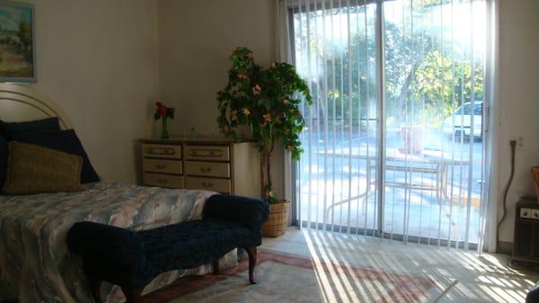 bedroom with view of patio/balcony