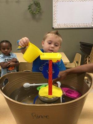 This pouring station teaches all kids of STEAM concepts (cause+effect, gravity, etc.), but this student just knows it's fun!