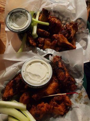 Yummy hot (front) and teriyaki (back)  wings finished on the grill. Their blue cheese dressing is very good.