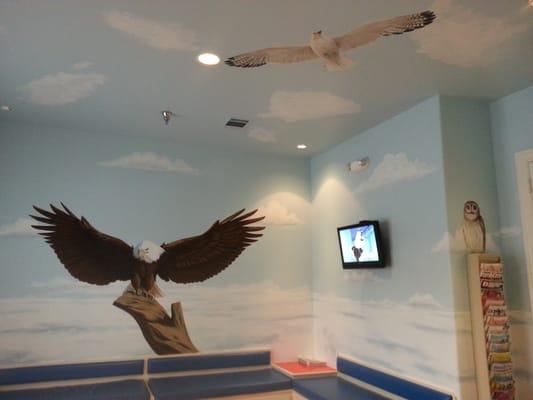 Nice child-friendly waiting room with more awesome animal artwork on the walls and ceiling.