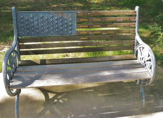 Stars on left, name plates on bench slats to simulate US flag