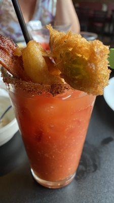 The Good Boy (Bloody Mary, Tajin rim, garnish with celery, fried pickle, bacon, mozzarella stick and onion ring)