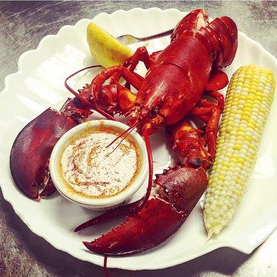 Lobster with a tomato, garlic butter and fresh local corn