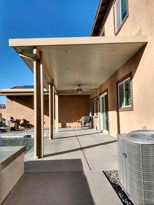 Attached two-tone solid roof patio cover to extend the homes living space.