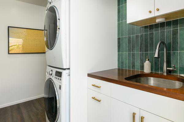 Woodland Hills, Laundry room with white laminate doors, Green tile splash, and a custom wood counter top.