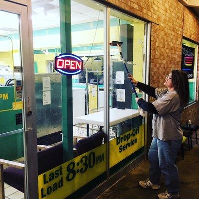 One of the new owners, she is cleaning the windows.