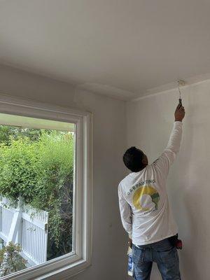 Painting living room ceiling.