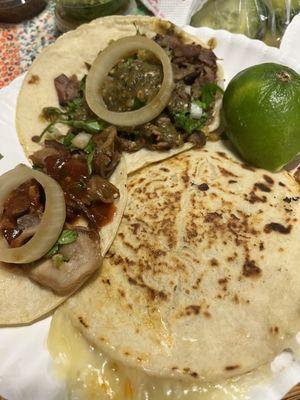 Left: Taco de Buche Top: Taco de Asada Right: Mulita de Al Pastor Also pictured are sliced cucumbers