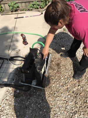 Gina servicing a window unit.